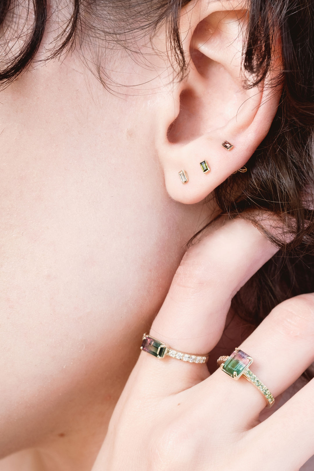 earrings stacked in close up photo of model