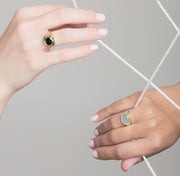 two womens hands wearing yellow gold signet rings