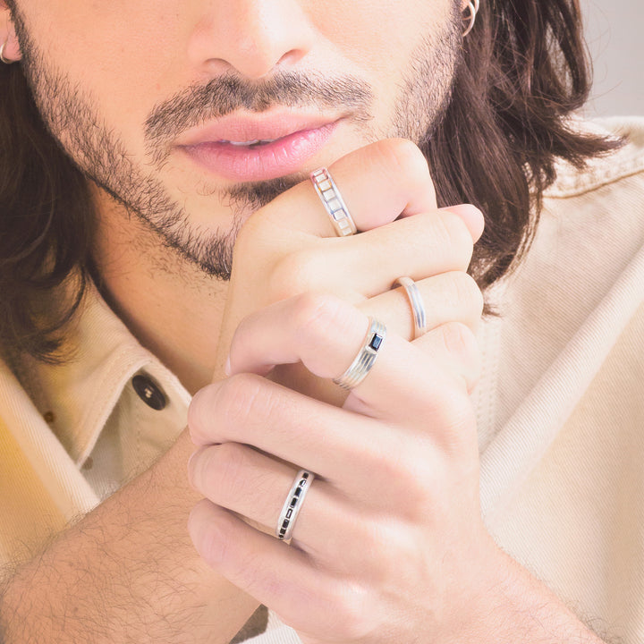close up of a man with clasped hands wearing a set of white gold mens engagement rings